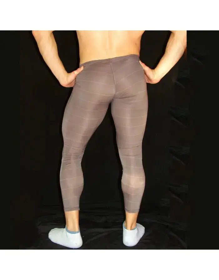Men's fitted gym tights in a brown shade made of stretchy material shown from the back by Arroyman.