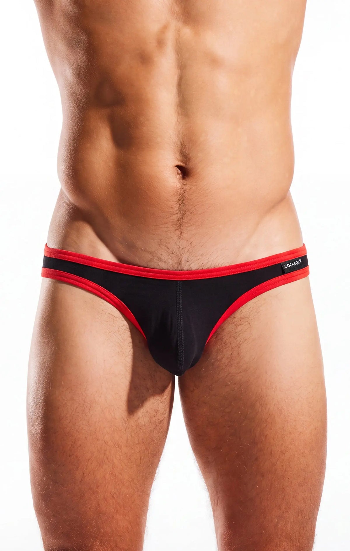 Torso and thighs of a person wearing black briefs with red trim on a white background.