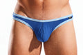 Close-up of a person's midsection wearing blue briefs with light blue trim on a white background.