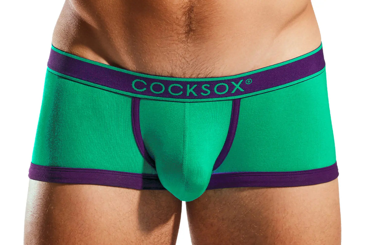 Close-up of green boxer briefs with a purple waistband on a person.
