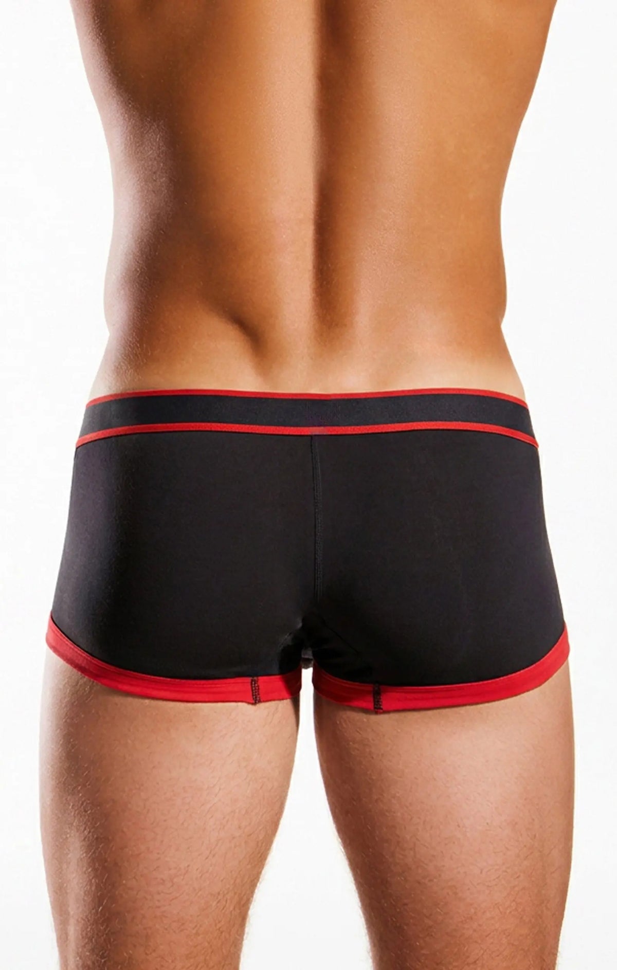 Rear view of a person wearing black trunks with red trim on a white background.