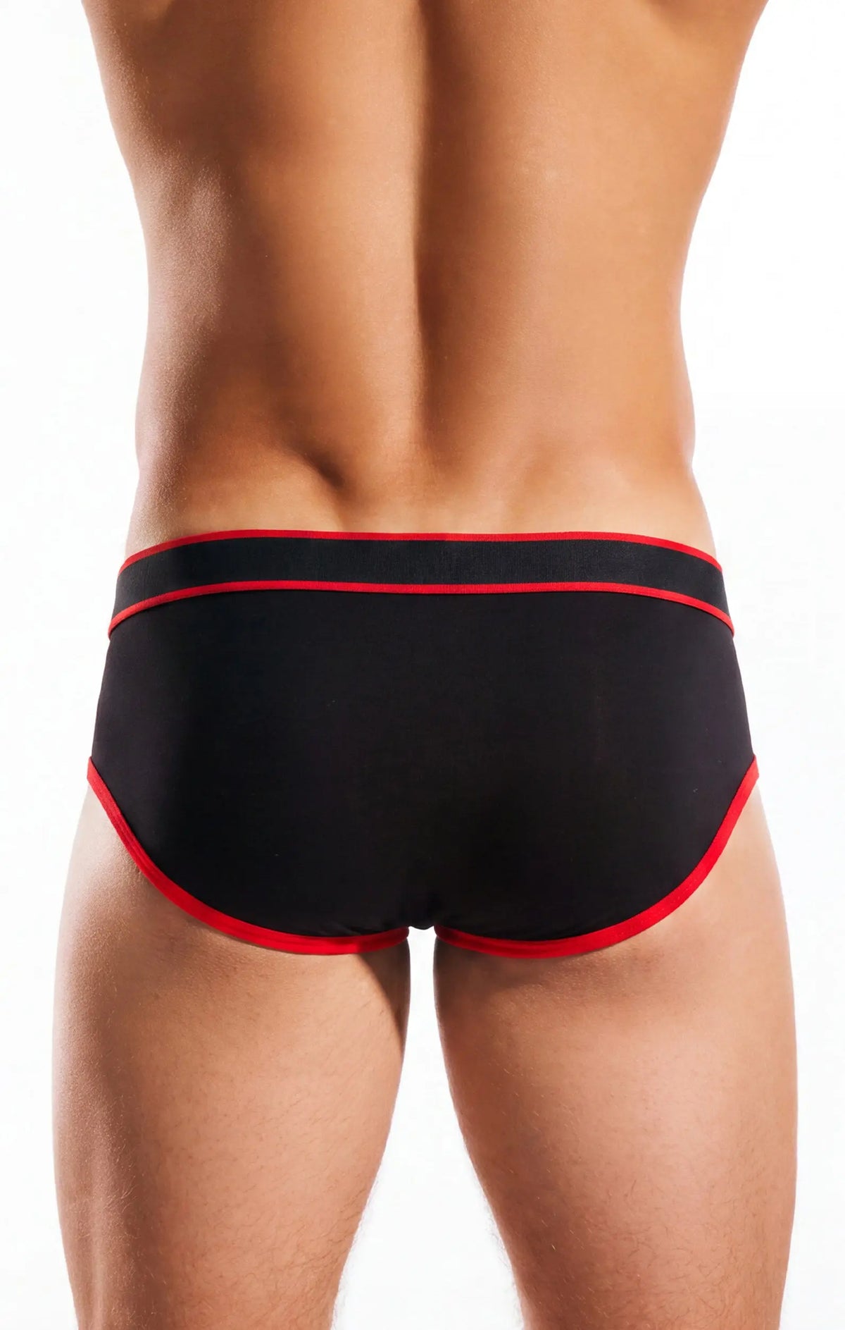 Rear view of a person in black briefs with red trim on a white background.
