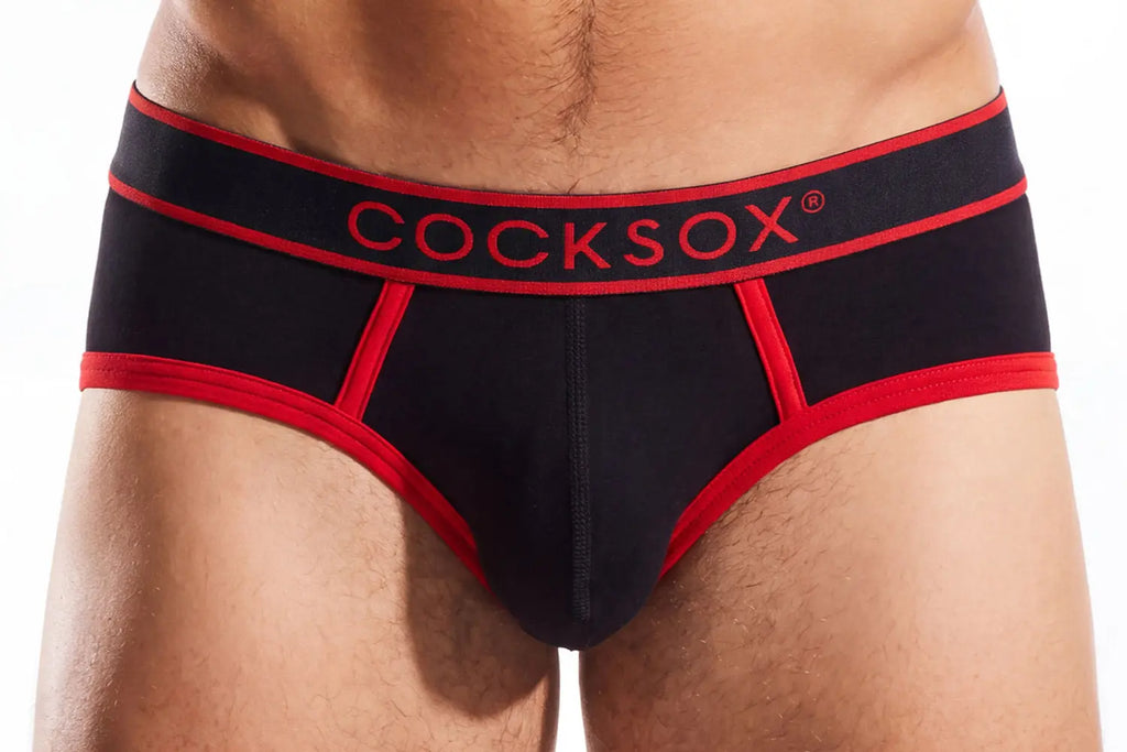 Close-up of a person's midsection wearing black briefs with red trim and a red waistband.