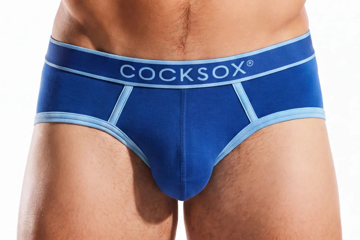 Close-up of a person's midsection wearing blue briefs with a light blue waistband.