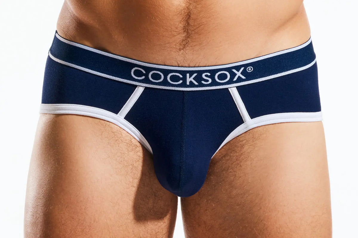 Close-up of a person's midsection wearing navy blue underwear with white trim and a white waistband.