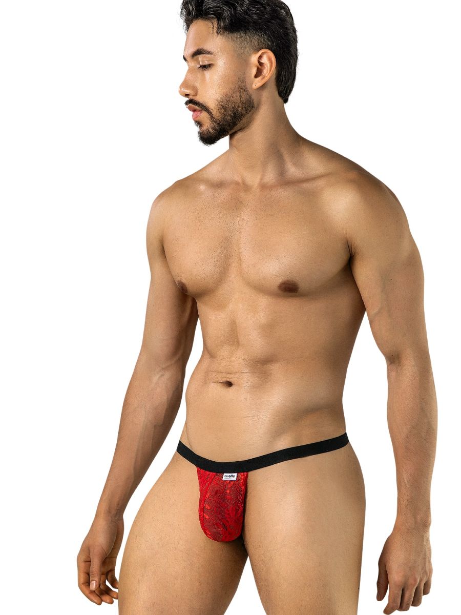 Angled front view of a model wearing a CandyMan red lace thong with a black waistband.