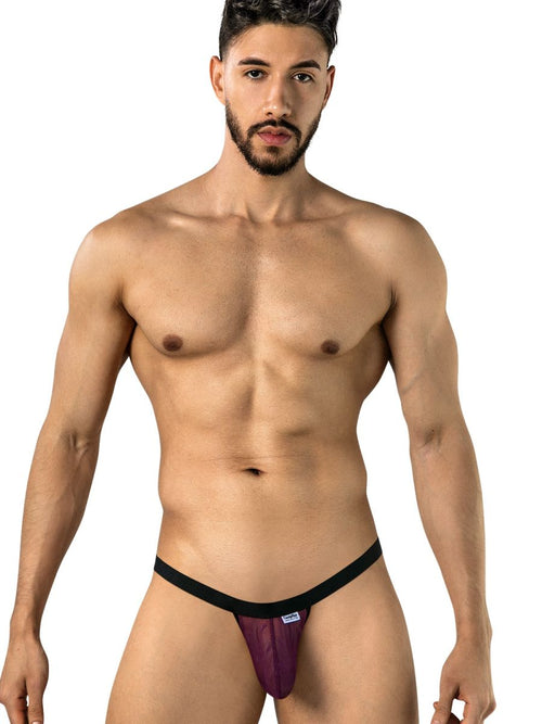 Man wearing wine mesh thong with black waistband on white background