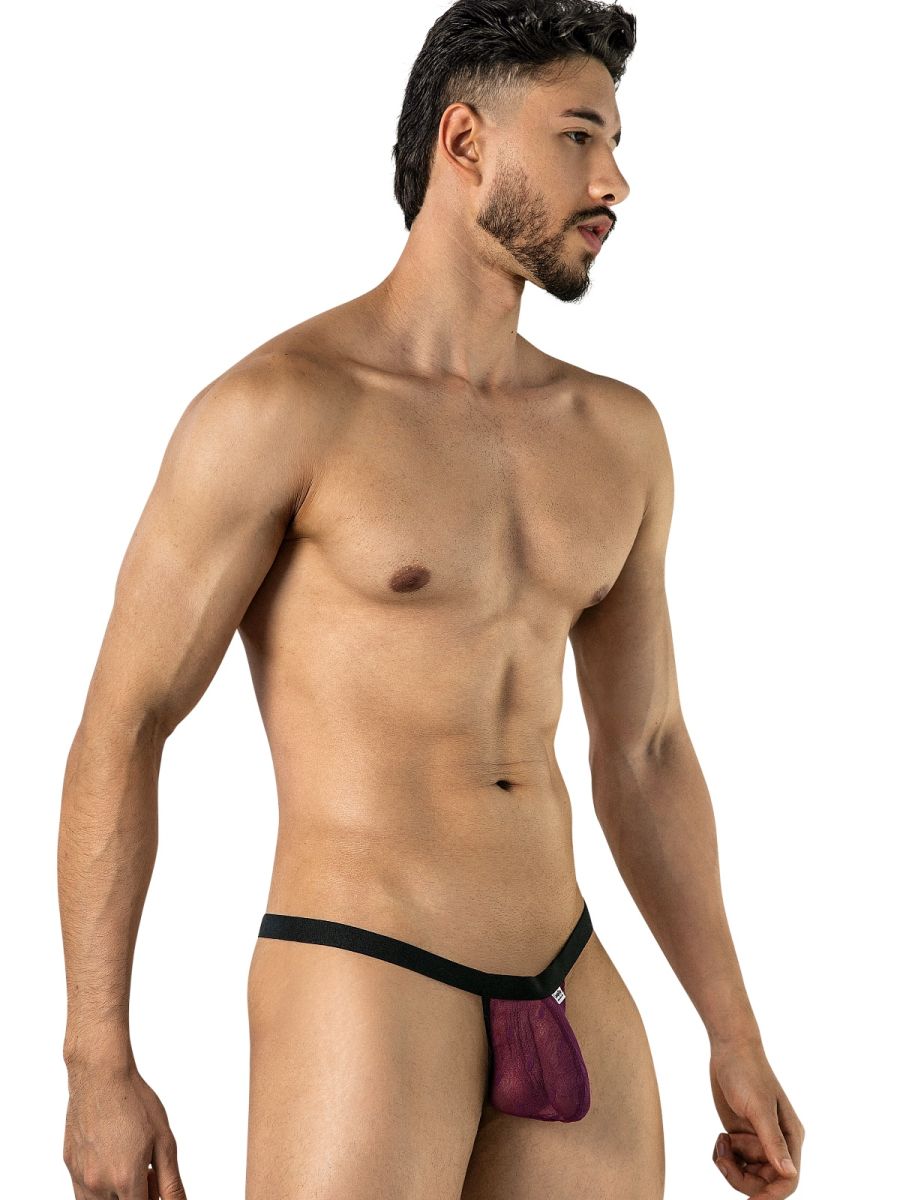 Angled front view of a model wearing wine mesh thong underwear with a black waistband.