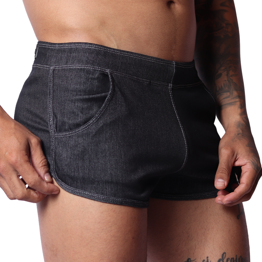Gigo black denim hot shorts, side view, showing curved hem, white contrast stitching, and front pocket detail.