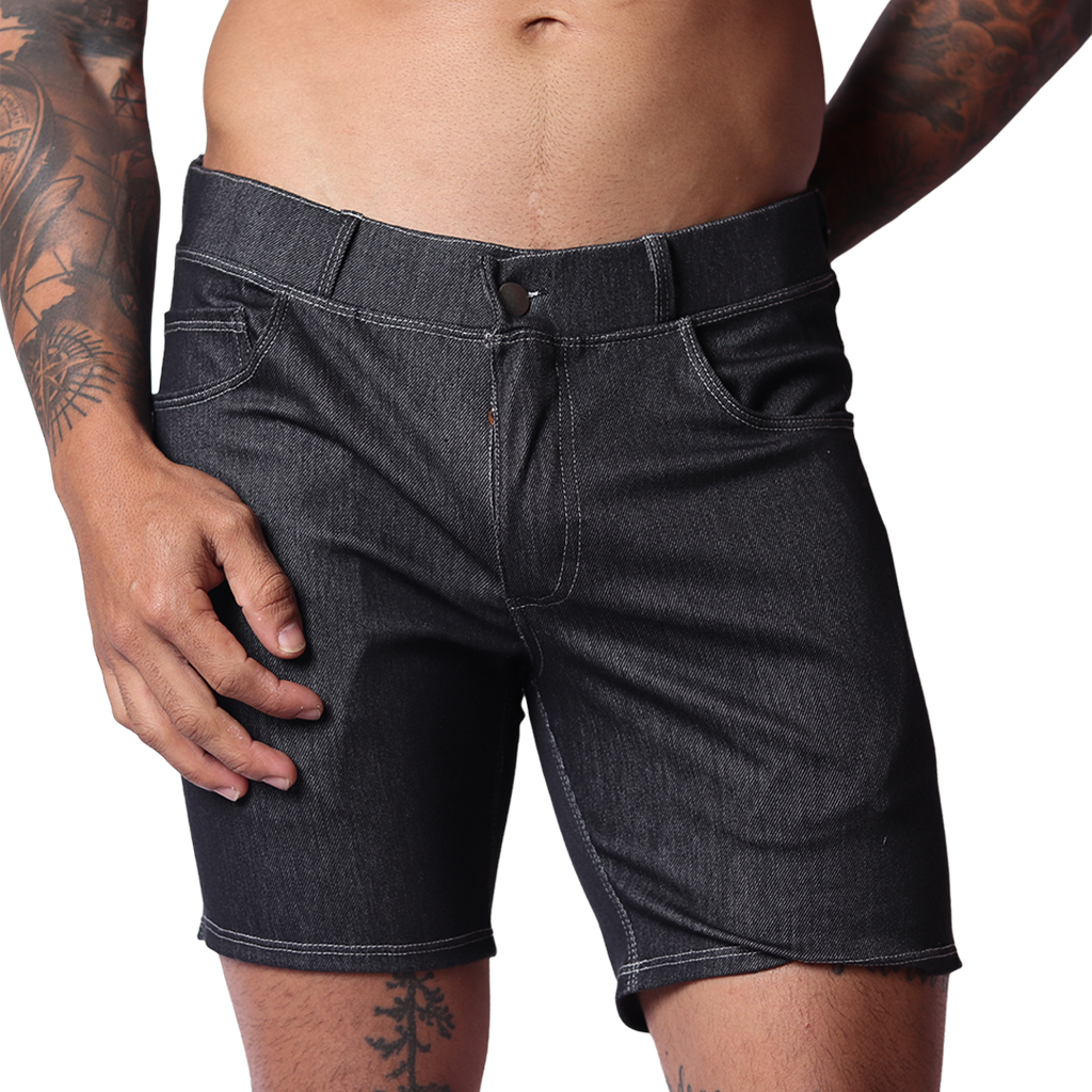 Front view of Gigo menâ€™s black denim short with belt loops, fly button, and contrast stitching on a tattooed model.