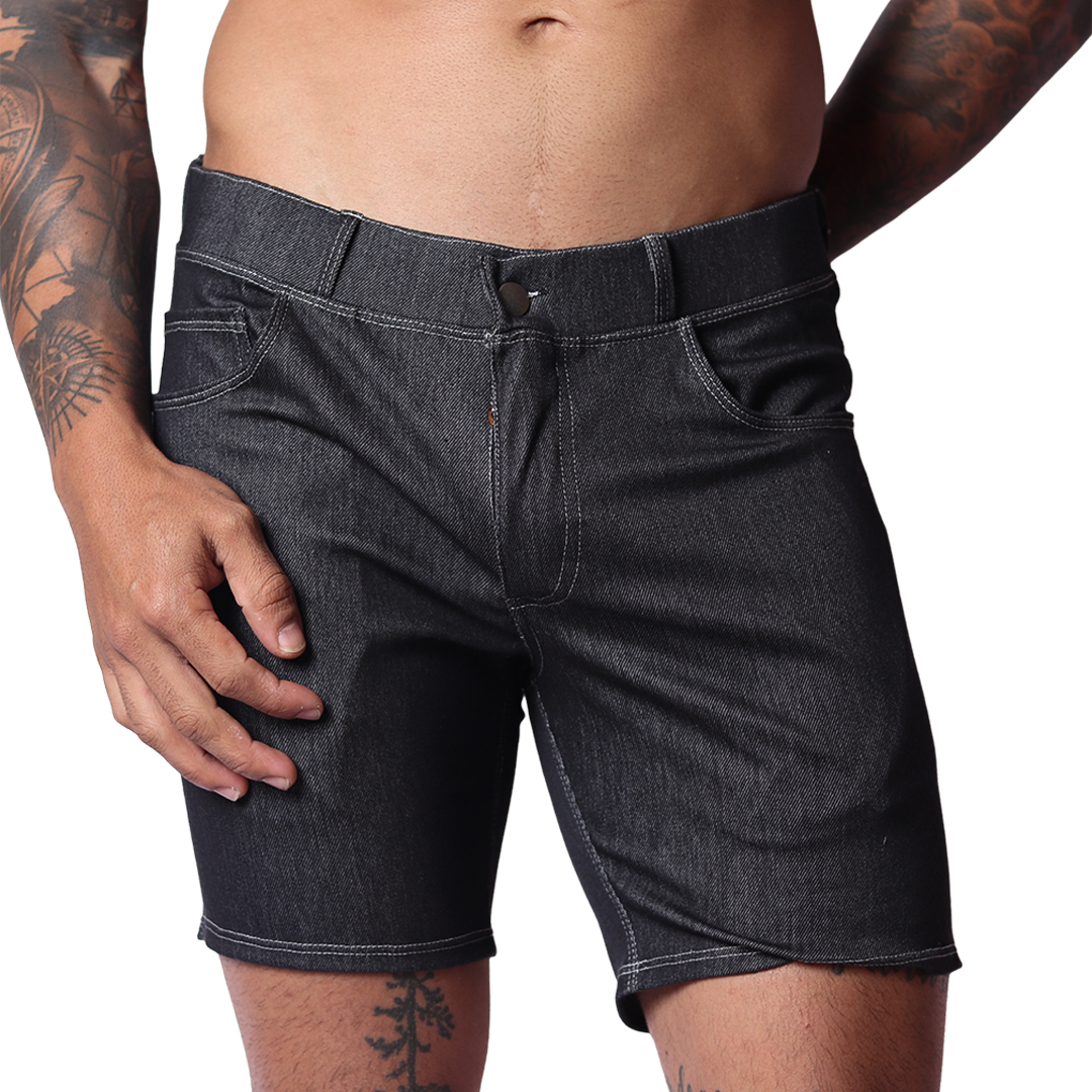 Front view of Gigo menâ€™s black denim short with belt loops, fly button, and contrast stitching on a tattooed model.