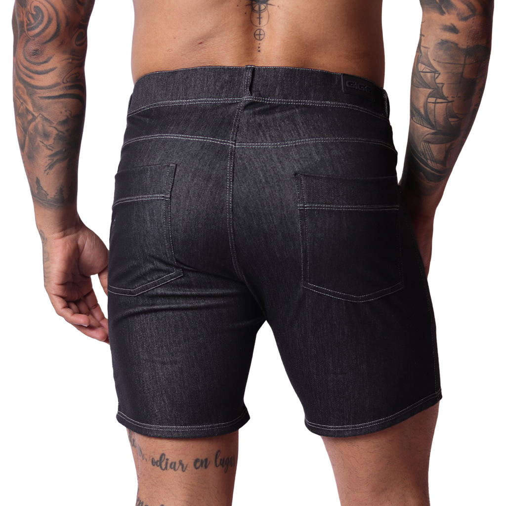 Back view of Gigo black denim shorts with two pockets and white contrast stitching on a tattooed male model.