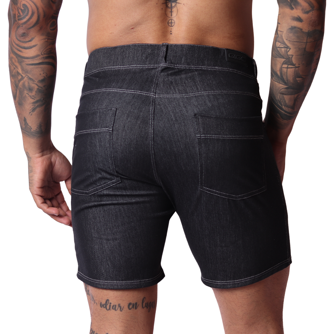 Back view of Gigo black denim shorts with two pockets and white contrast stitching on a tattooed male model.