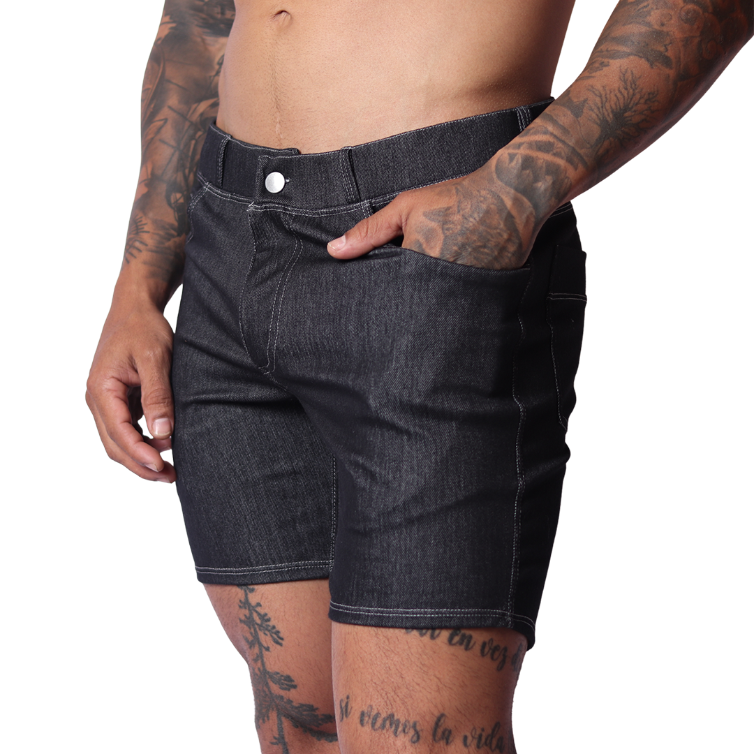 Side view of Gigo black denim shorts featuring contrast stitching, button fly, and slim-fit silhouette on tattooed model.