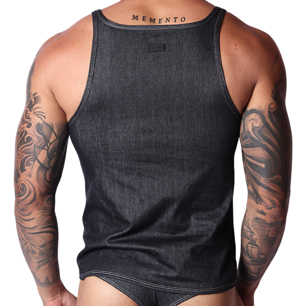 Back view of black denim Gigo tank top with branded tag, modeled on a tattooed man.