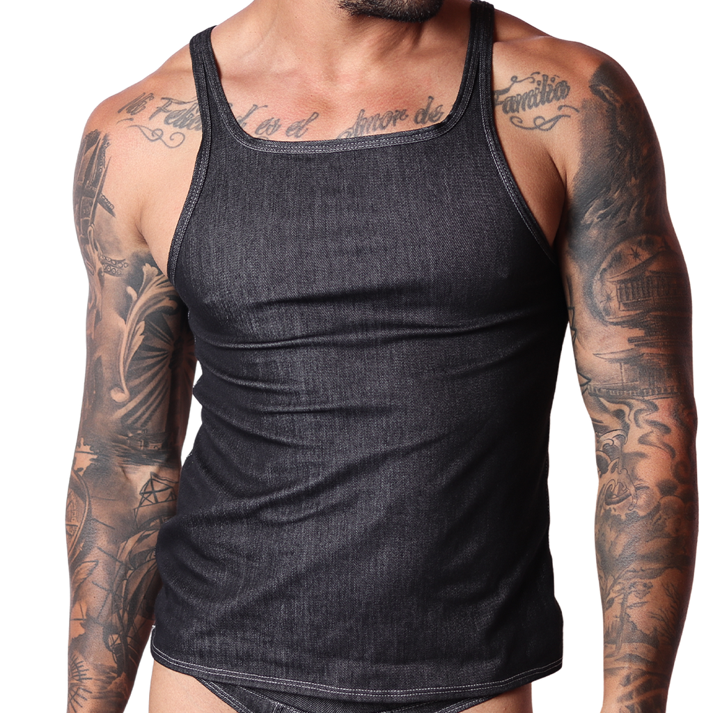 Front view of a Gigo black denim tank top with contrast stitching on a tattooed male model, black background.