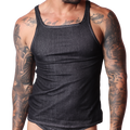 Front view of a Gigo black denim tank top with contrast stitching on a tattooed male model, black background.