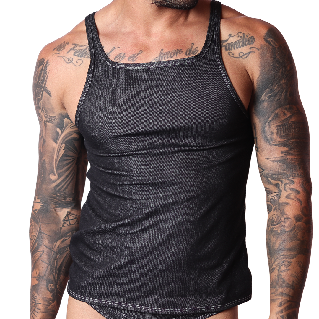 Front view of a Gigo black denim tank top with contrast stitching on a tattooed male model, black background.