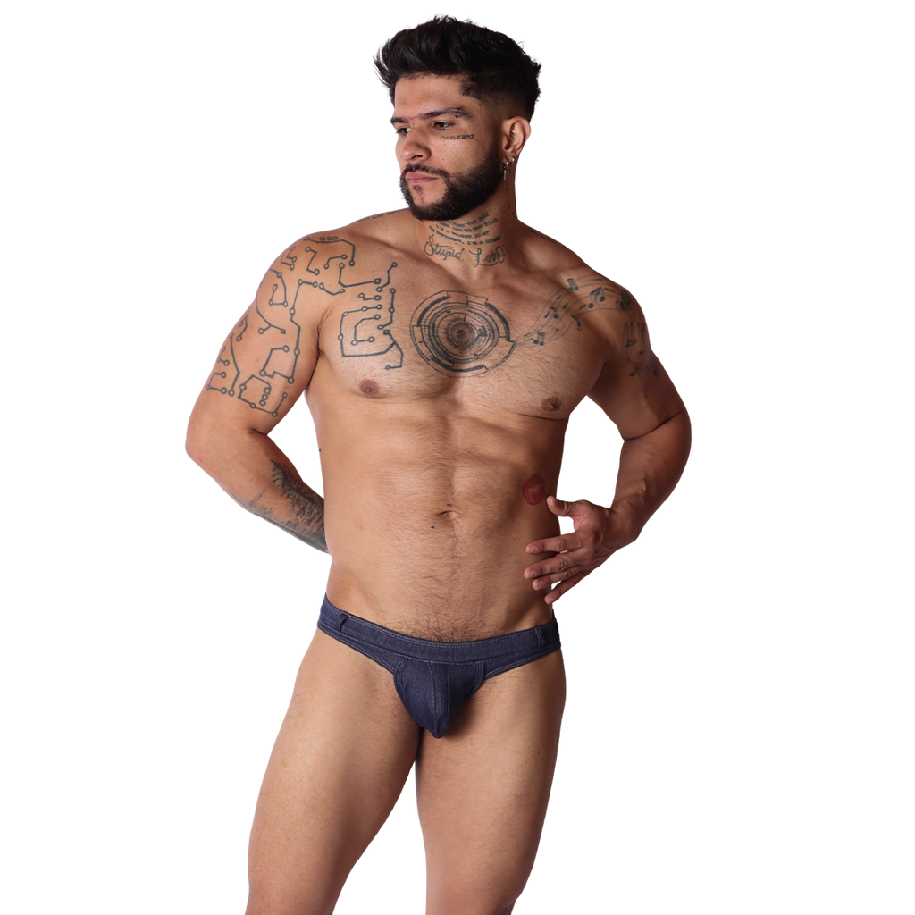 Front view of Gigo blue denim fabric G-string underwear on a tattooed man with a textured pouch and slim waistband.