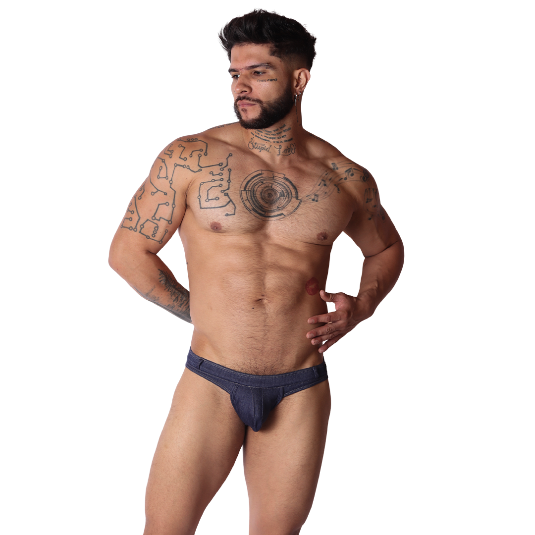 Front view of Gigo blue denim fabric G-string underwear on a tattooed man with a textured pouch and slim waistband.