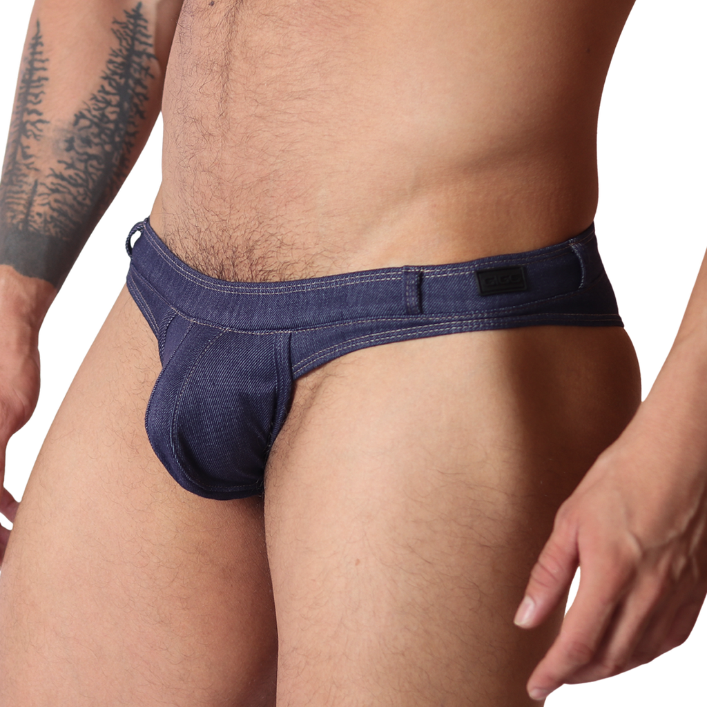 Gigo denim blue G-string thong, side view. Features blue jean-style fabric, contrast stitching, and a branded waistband.