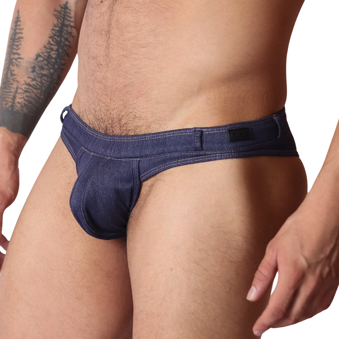 Gigo denim blue G-string thong, side view. Features blue jean-style fabric, contrast stitching, and a branded waistband.