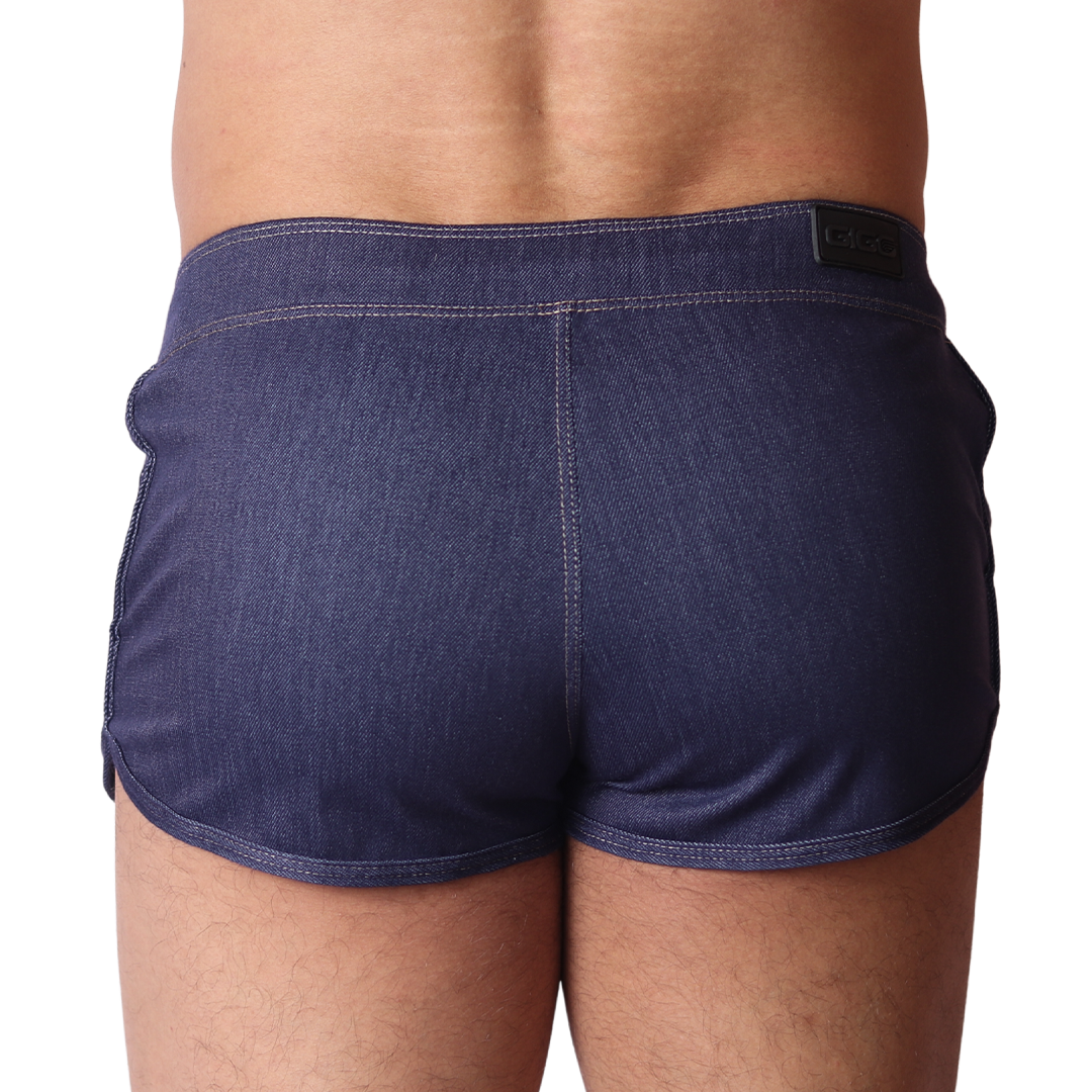 Back view of Gigo blue denim hot shorts with contrast stitching and branded waistband patch on a black background.