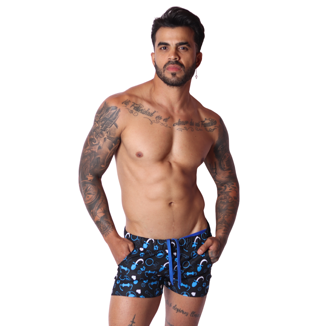 Front view of Gigo blue fabric short with a dog-themed print and drawstring, worn by a tattooed man.