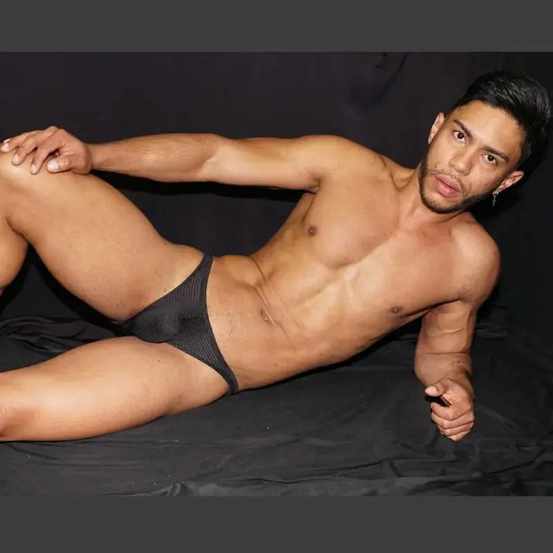 Men's black mesh bikini underwear by Arroyman featuring a sleek design and lightweight material shown on a model.