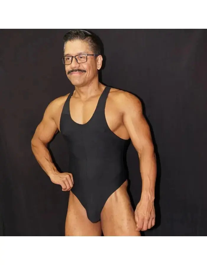 Black microfiber bodysuit thong for men featuring a sleeveless design and a snug fit modeled by a man by Arroyman
