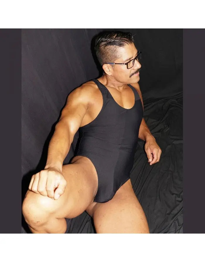 Black microfiber bodysuit thong by Arroyman featuring a sleek design and racerback style worn by a model.
