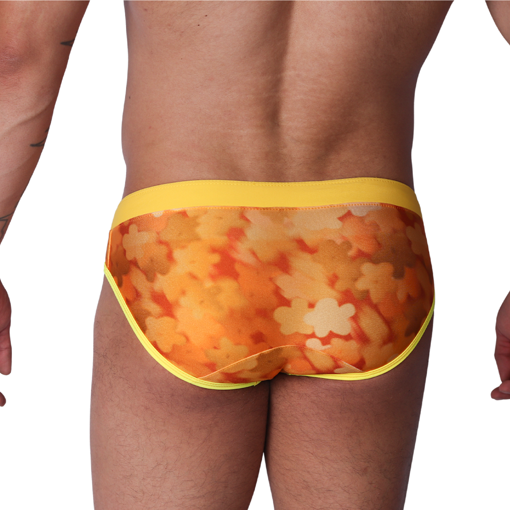 Back view of Gigo yellow floral print swim brief in smooth fabric with solid yellow waistband and trim.