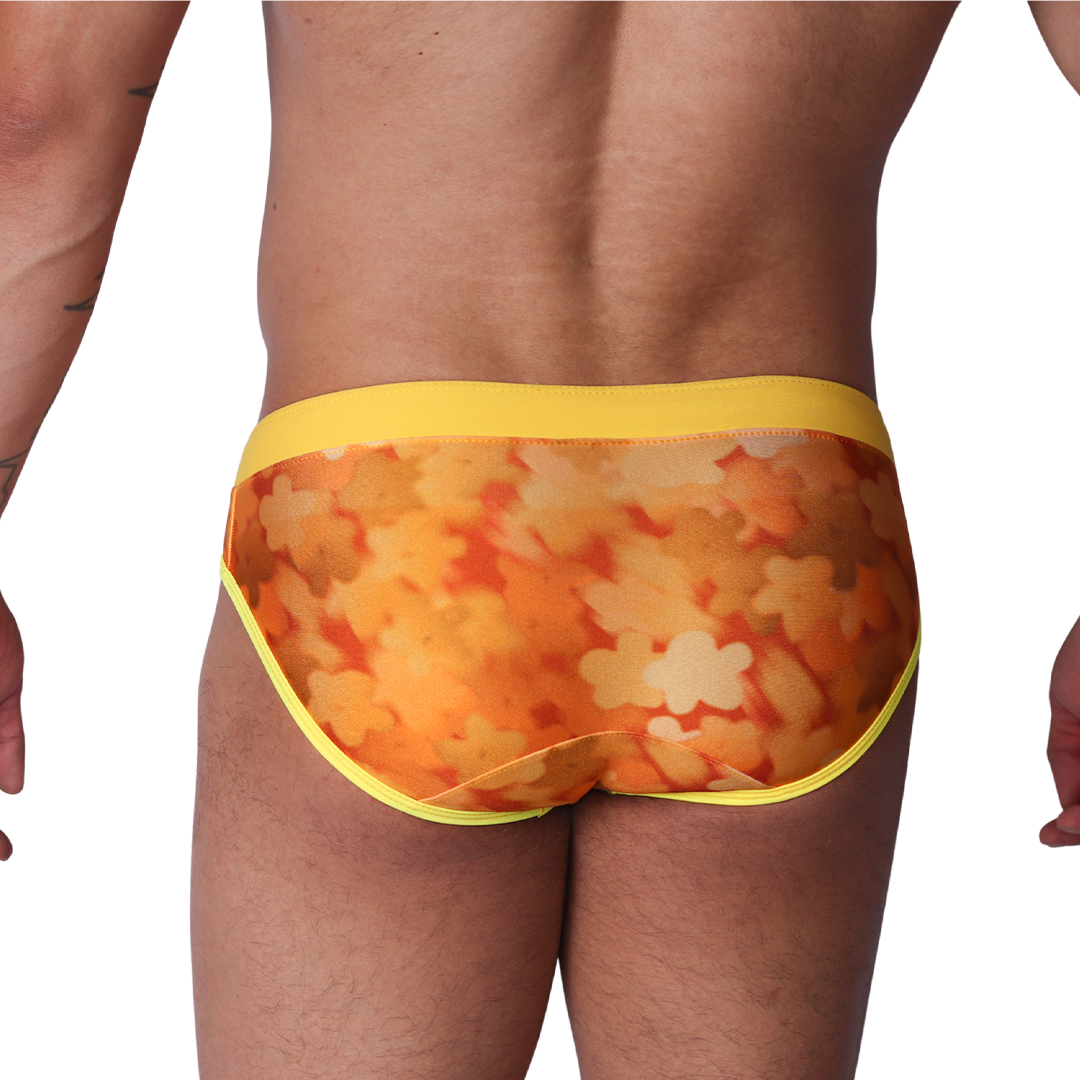 Back view of Gigo yellow floral print swim brief in smooth fabric with solid yellow waistband and trim.