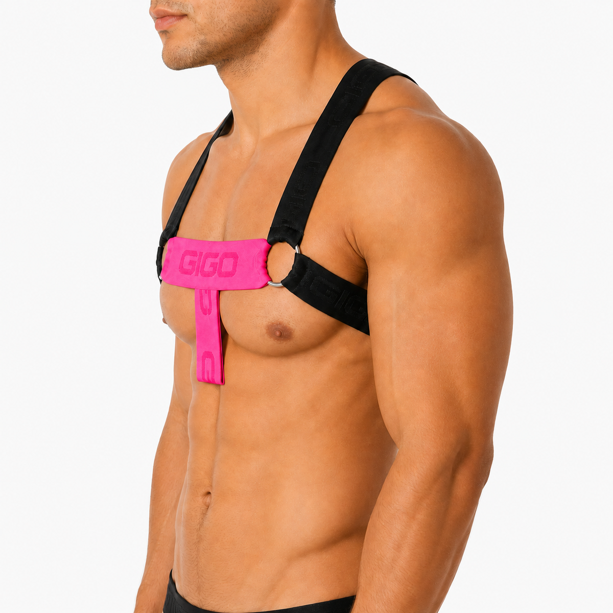 Side view of Gigo Flux harness in fuchsia and black elastic fabric with silver O-ring accents on a muscular model.