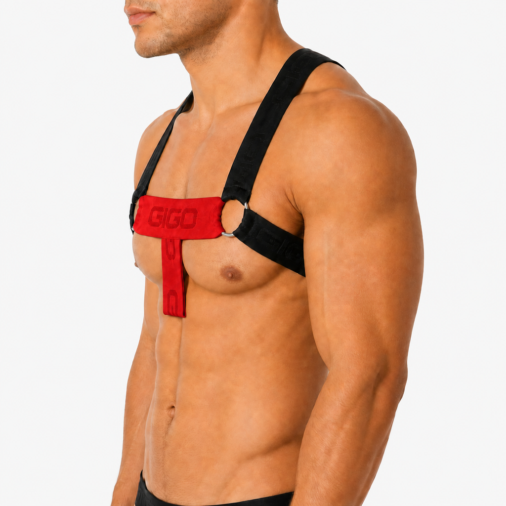 Side view of Gigo Flux red and black fabric harness with branded straps and metal rings on a muscular model.