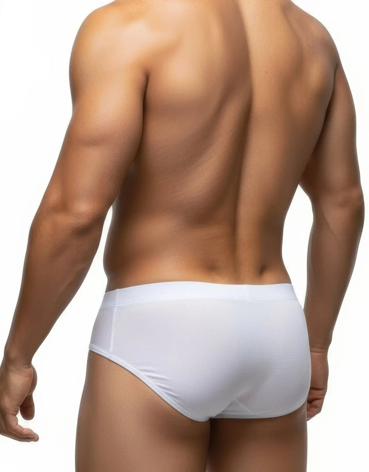 Rear view of a person in white briefs against a white background.