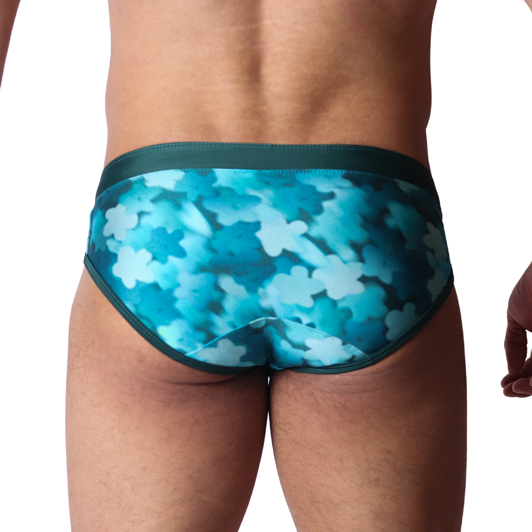 Back view of Gigo blue floral print swim brief in smooth stretch fabric with solid dark trim.