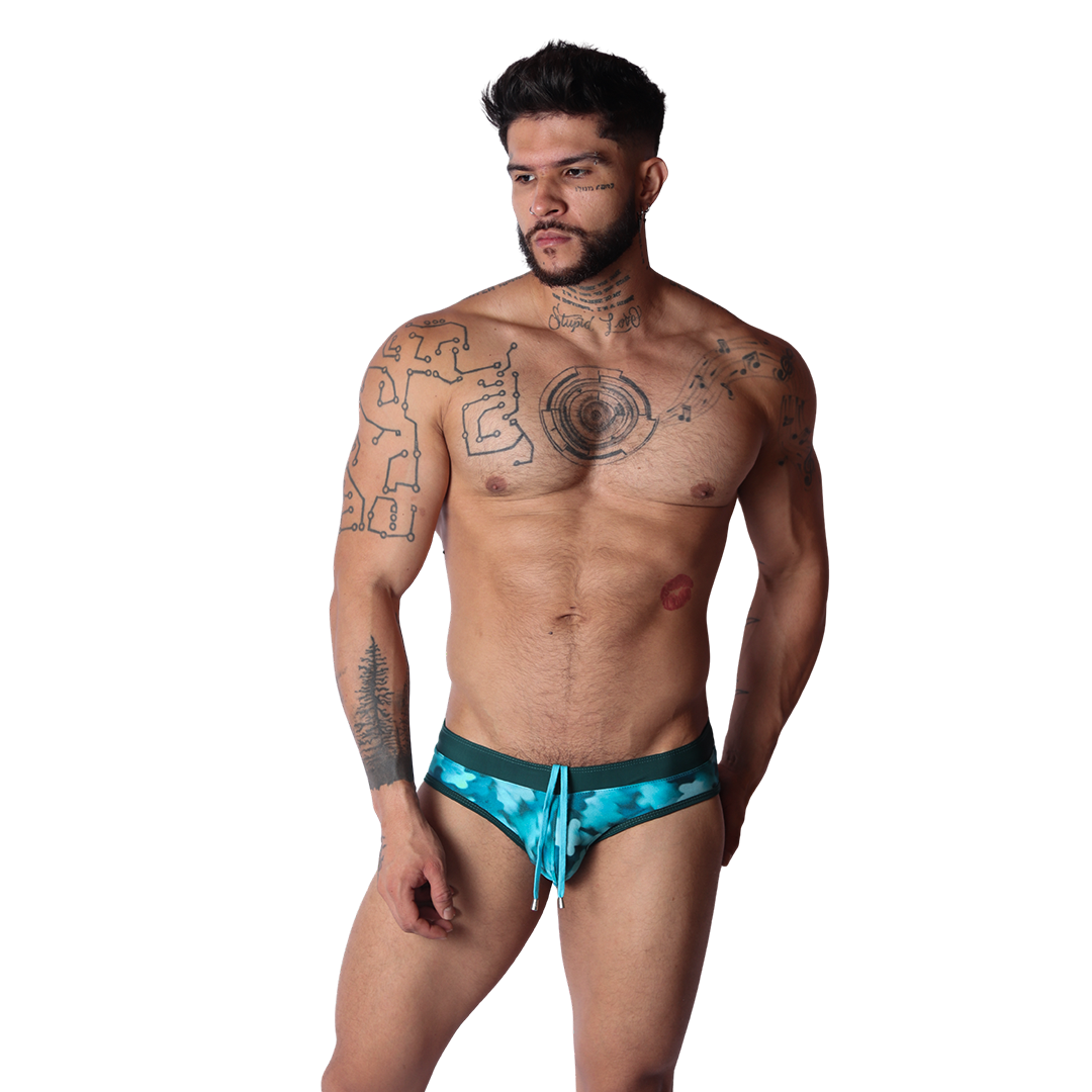 Front view of Gigo blue floral swim brief with a dark green waistband and adjustable drawstring on a male model.