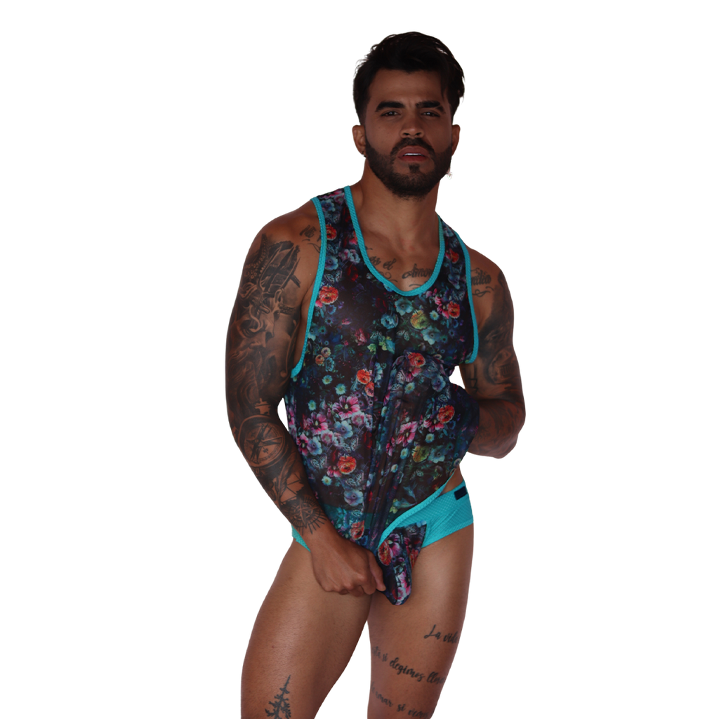 Front view of Gigo Garden Blue mesh floral tank top with turquoise trim on a tattooed model.