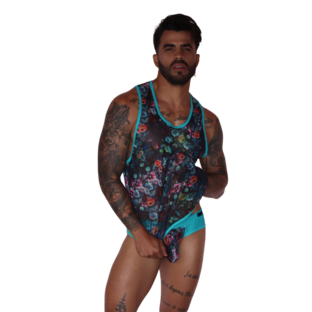 Front view of Gigo Garden Blue mesh floral tank top with turquoise trim on a tattooed model.