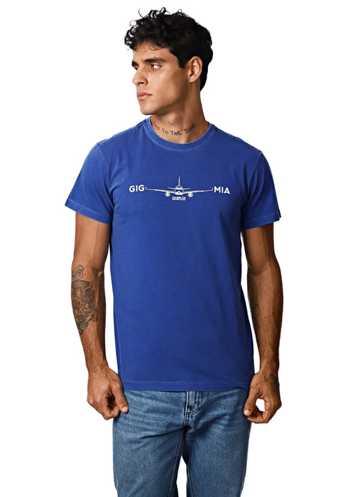 Model wearing a blue T-shirt with small pale lettering across the chest.