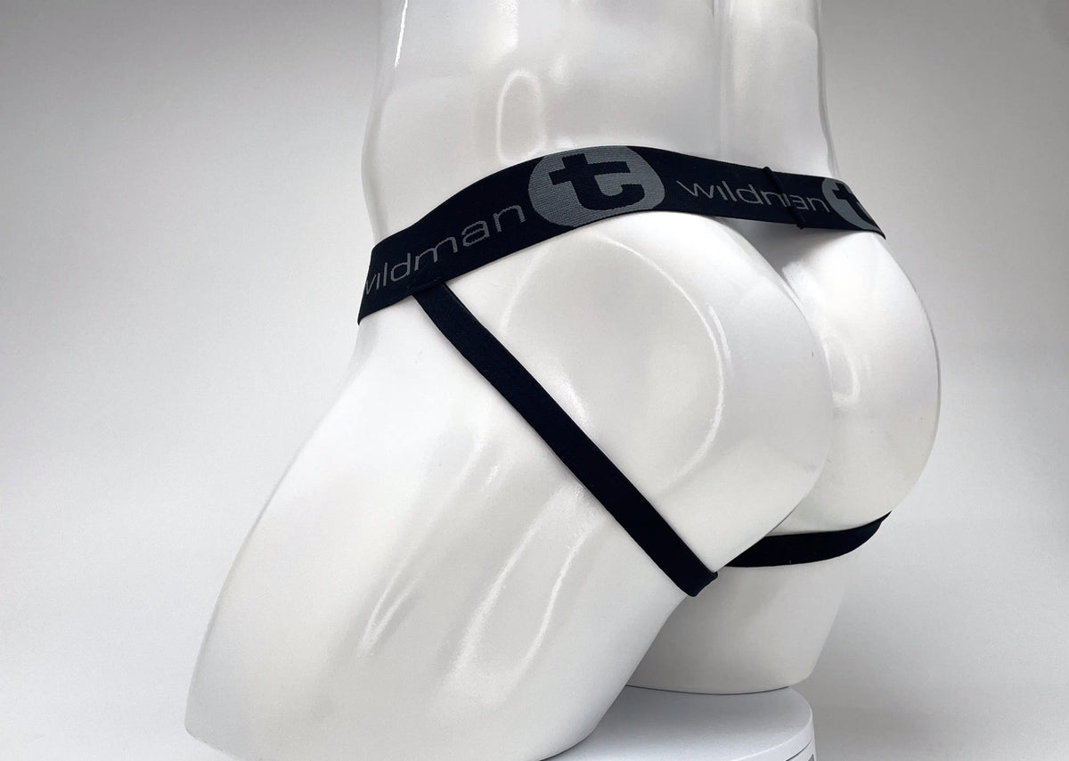 White mannequin lower torso wearing black strapped underwear with gray text.