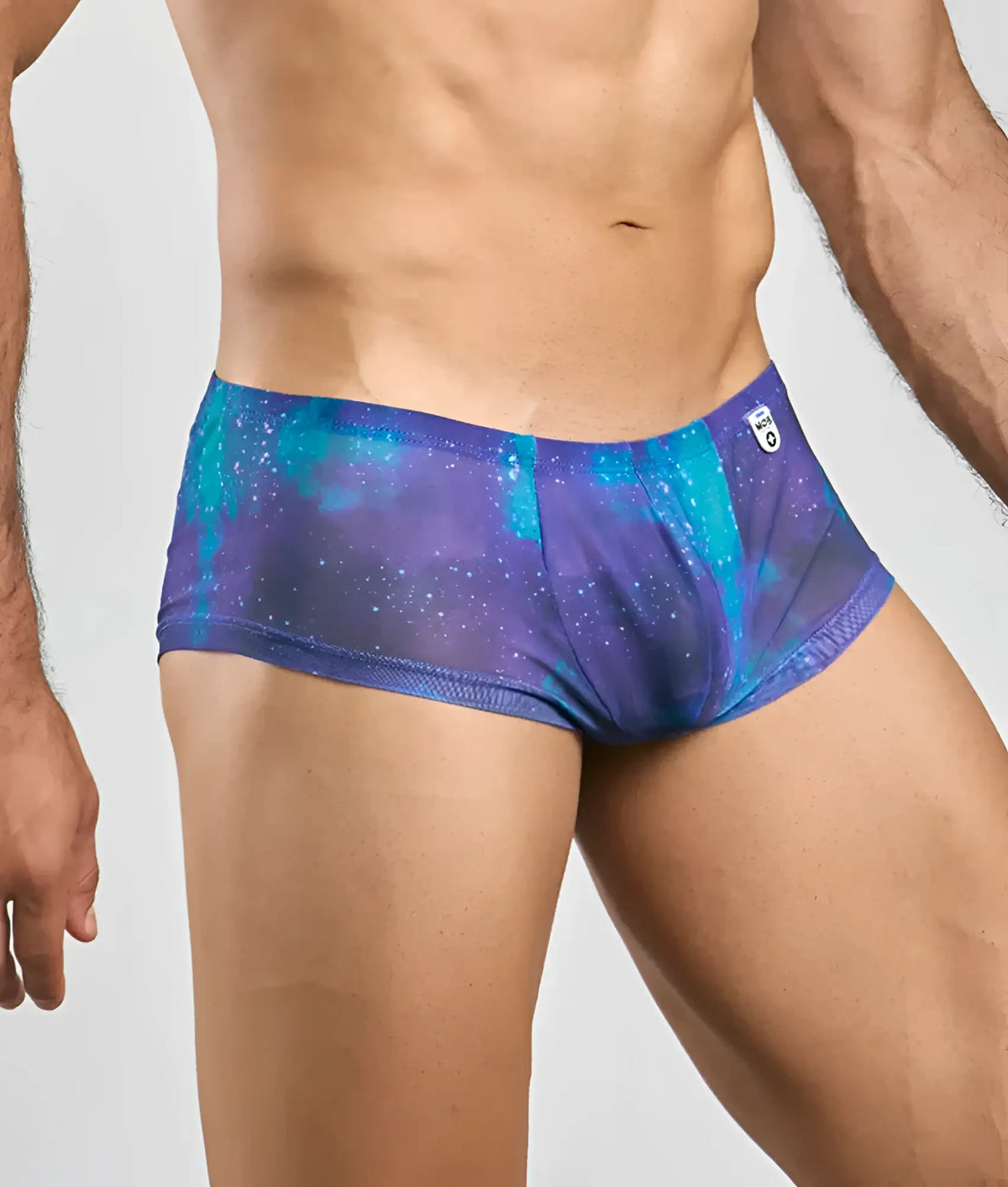 MOB menâ€™s sexy sheer hip brief in purple and teal galaxy pattern with subtle mesh texture and breathable fabric