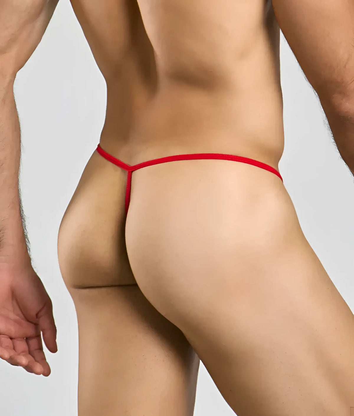 Red thong with thin smooth elastic band shown from the back in mob mens sheer t back thong style