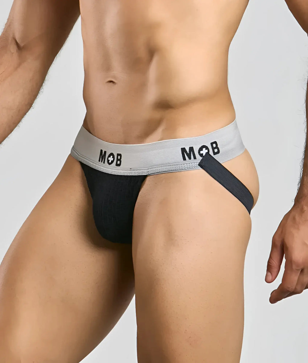 Black mob classic jock 3 inches briefs with gray waistband, mob logo, and black side strap, back view