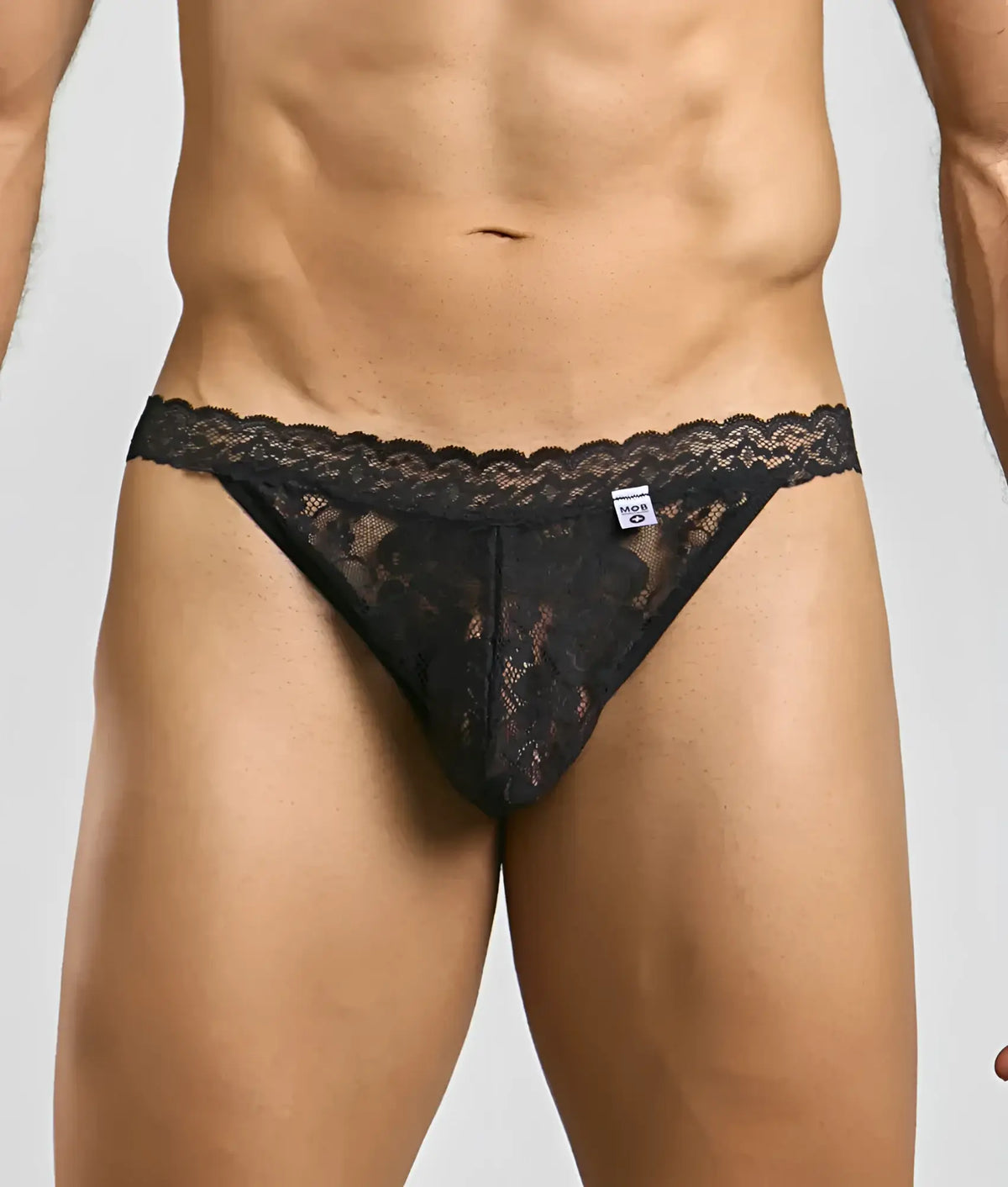 Black lace thong with intricate floral patterns and scalloped edge from mob menâ€™s lace jockstrap collection