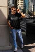Black short-sleeved cotton t-shirt with emotional support top printed in white and gray across the chest