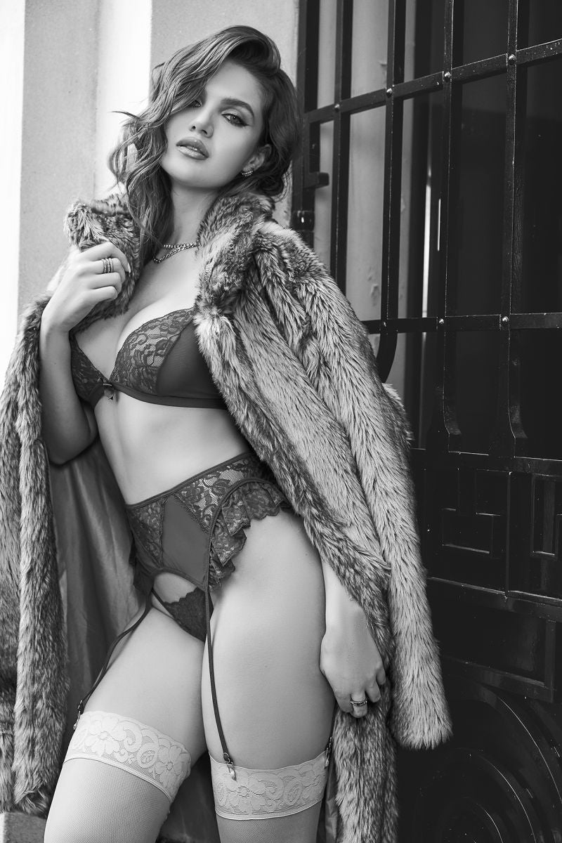 Model wearing Mapale 80031 burgundy three-piece lingerie set with lace and garter straps under a fur coat.