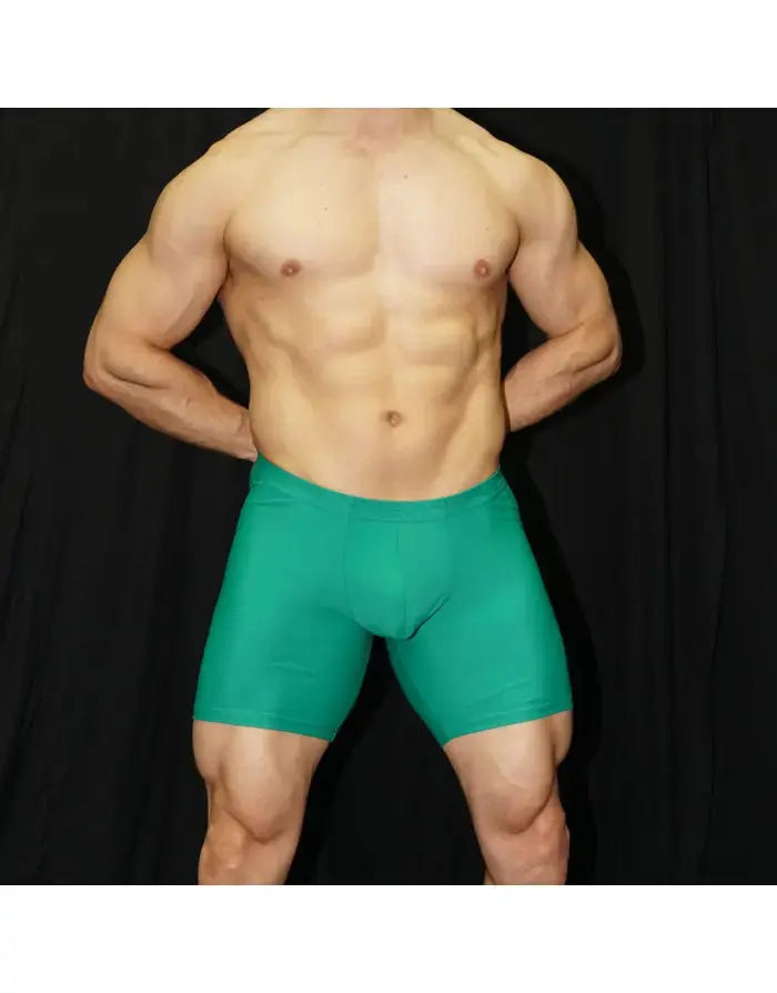 Green compression shorts by Arroyman featuring a snug fit and smooth fabric shown on a model with a neutral background.