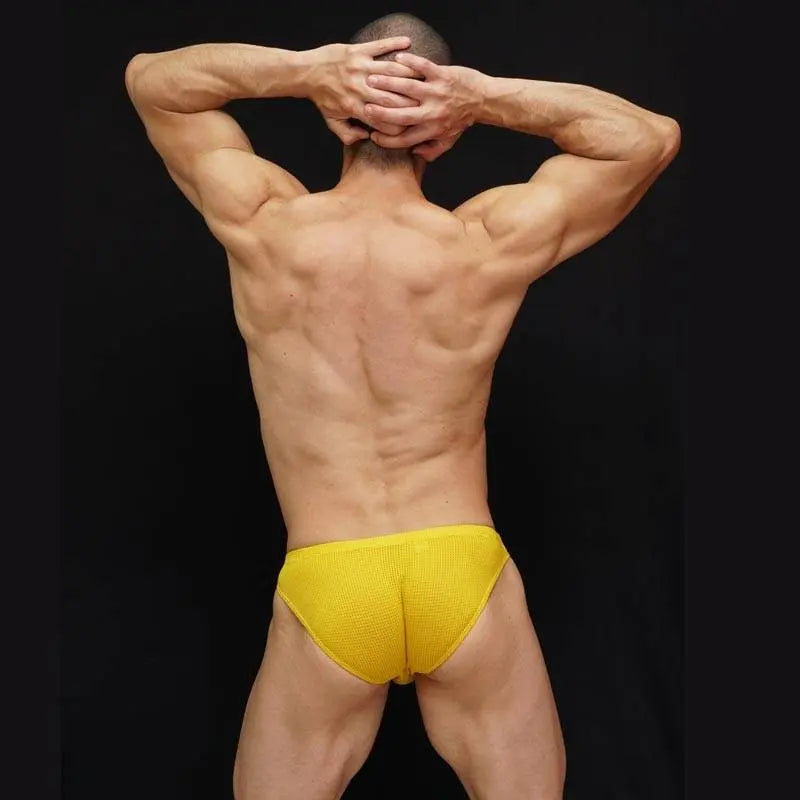 Men's yellow mesh bikini underwear by Arroyman featuring a snug fit and breathable fabric shown from the back.